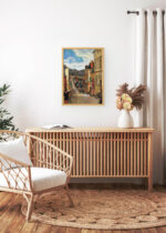 Aranżacja wnętrza, na ścianie wisi plakat w ramce: Paul Gauguin Pont-Aven bretońska uliczka 1888