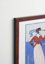 Aranżacja wnętrza, na ścianie wisi plakat w ramce: Kostium jachtowy George Barbier 1914 Art Deco