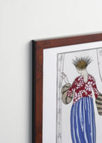 Aranżacja wnętrza, na ścianie wisi plakat w ramce: Manteau de Théâtre George Barbier art deco moda