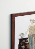 Aranżacja wnętrza, na ścianie wisi plakat w ramce: Art Deco Rosalinde George Barbier 1922 moda