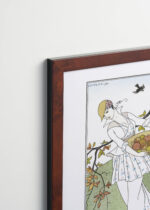 Aranżacja wnętrza, na ścianie wisi plakat w ramce: George Barbier Art Deco kobieta z owocami 1914