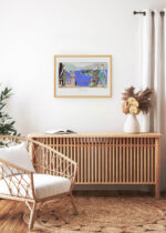 Aranżacja wnętrza, na ścianie wisi plakat w ramce: Isola Bella Piękna Wyspa Maggiore George Barbier 1914 Art Deco