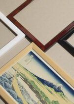 Widok z góry na cztery drewniane ramki, w jednej z nich oprawiony plakat Hokusai góra Fuji ukiyo-e japoński drzeworyt vintage