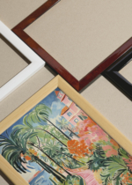 Widok z góry na cztery drewniane ramki, w jednej z nich oprawiony plakat Zejście na plażę nr 2