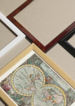 Widok z góry na cztery drewniane ramki, w jednej z nich oprawiony plakat stara mapa świata XVII wiek J. Seller kartografia vintage